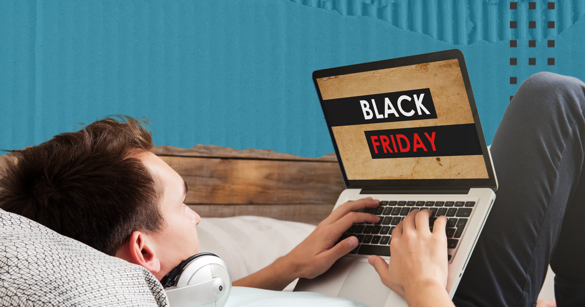 A customer sitting comfortably uses a laptop with a screen that reads 'Black Friday'